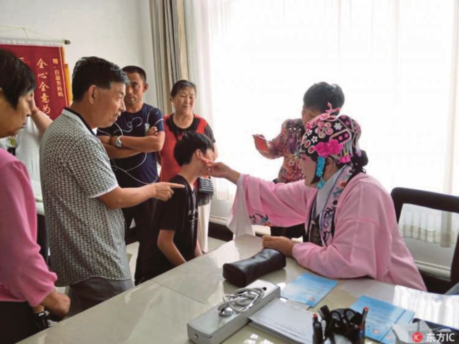 BAI Shufang merawat seorang pesakitnya yang mendapatkan rawatan. - Agensi