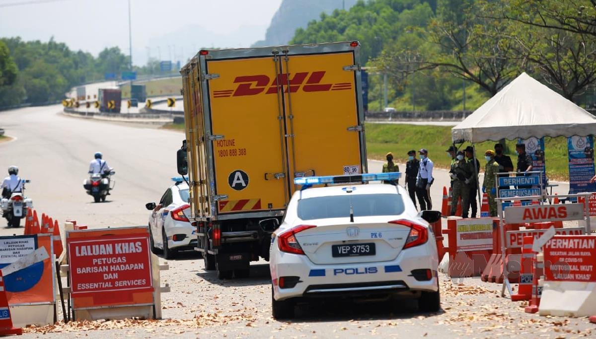 KENDERAAN polis mengiringi lori DHL yang membawa vaksin dari Pulau Pinang ke Perak, hari ini. FOTO Sharul Hafiz Zam.