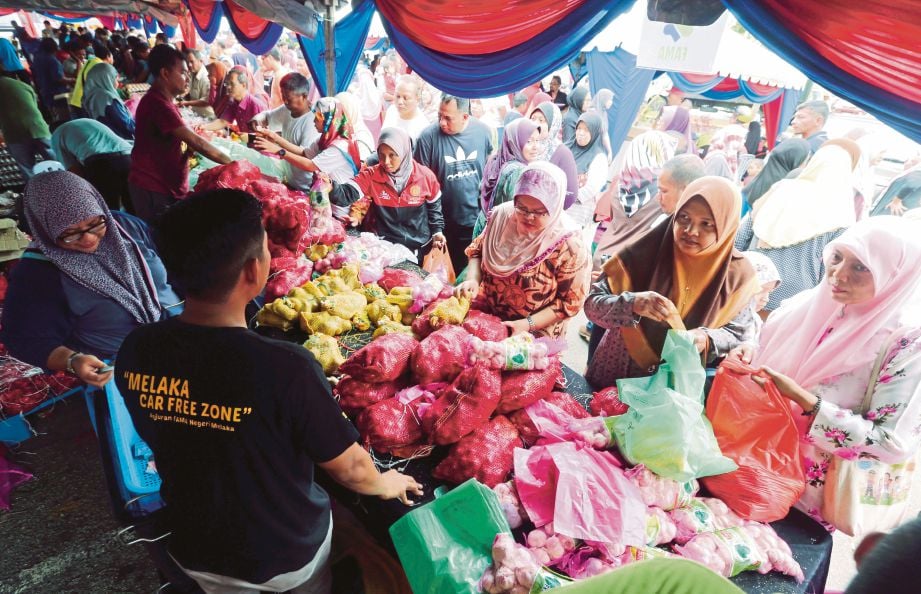 ORANG ramai mendapatkan minyak masak yang dijual ketika program di Masjid Tanah, Melaka, semalam.