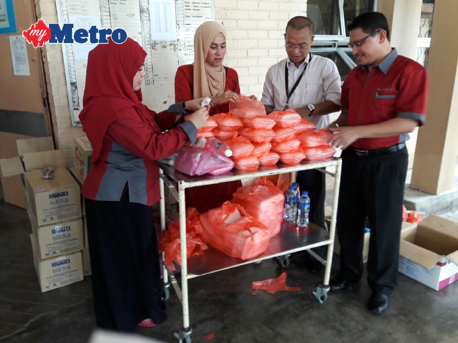 MOHD Fadzil (dua dari kanan) mengagihkan bantuan makanan di wad Bunga Raya 1 (BR1) HSA. Mohd Sabran Md Sani