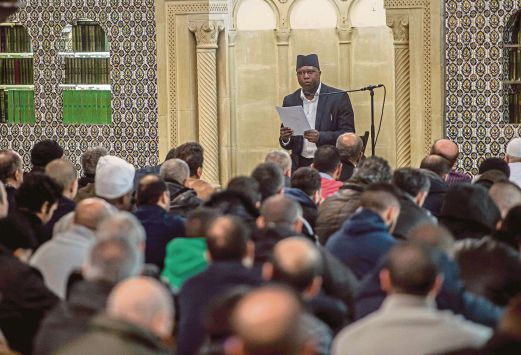 PENDUDUK Islam Brussels mendengar khutbah oleh khatib Mouhameth Galaye sebelum solat Jumaat di Masjid Jamik Brussels, semalam.  Ia Jumaat pertama selepas serangan pengganas di bandar raya itu. 