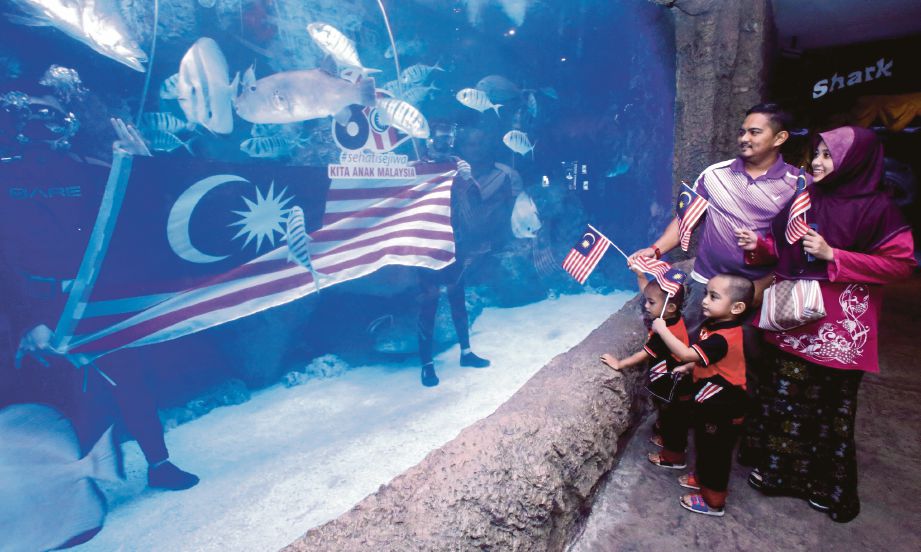 PENGUNJUNG tertarik melihat penyelam bersama Jalur Gemilang di Oceanarium, Pusat Beli-Belah The Shore, Melaka.