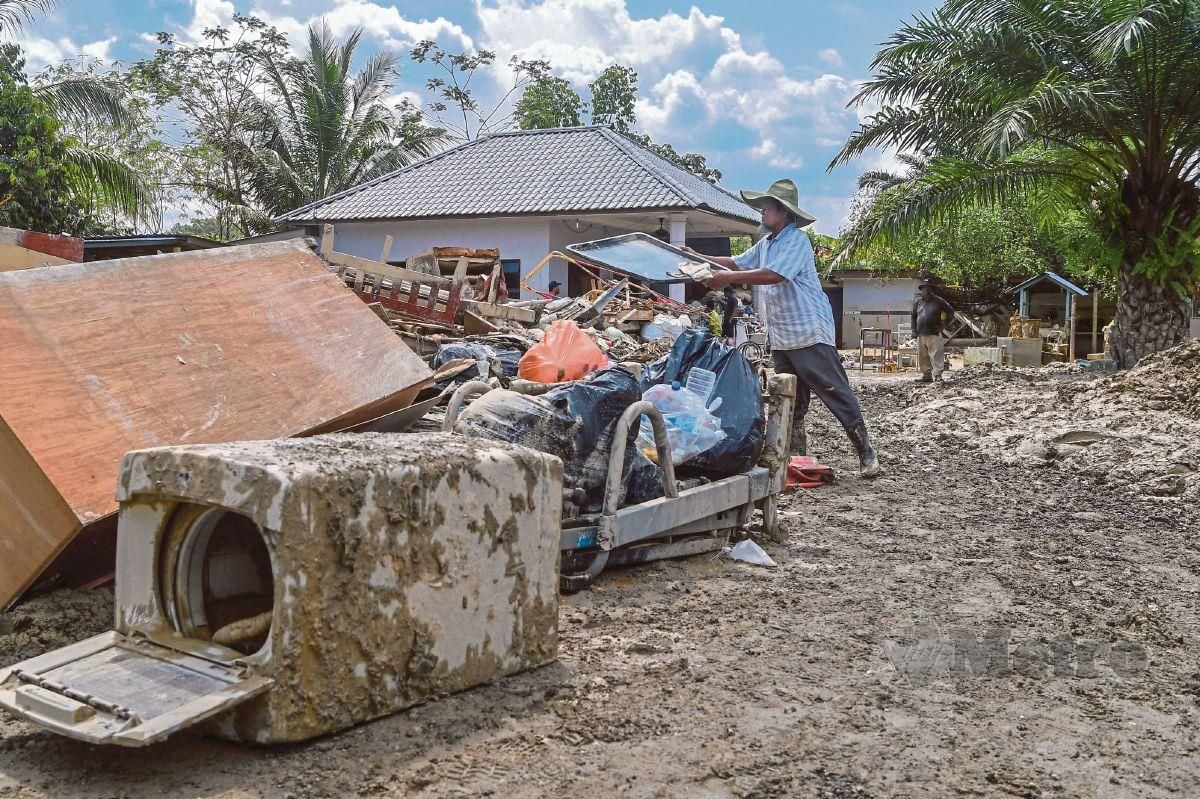 PEMILIK Riverview Homestay, Datuk Ja’apar Mansor terpaksa membuang perabot di rumah inap desanya akibat banjir. FOTO Bernama