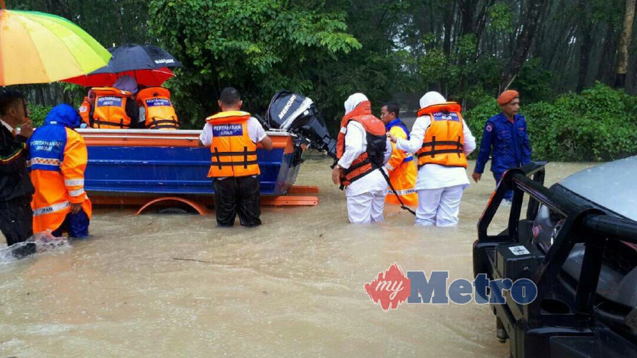 PASUKAN APM Kedah ditugaskan membantu mangsa banjir di Tanah Merah dan Pasir Mas. FOTO ihsan APM Kedah