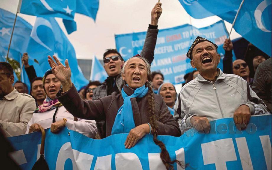 ETNIK Uighur di Brussels melaungkan slogan sambil memegang bendera mereka ketika melakukan demonstrasi.
