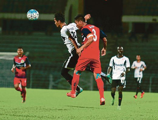   PEMAIN T-Team, Ahmad Takiyuddin Roslan  (depan) menanduk bola sambil dihalang kapten ATM, Badrul Hisham Sufian  di Stadium Perak, Ipoh. 