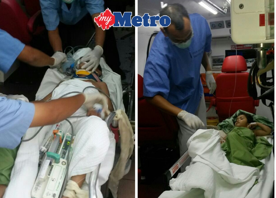 Dua beradik yang cedera dihantar ke hospital dengan ambulans. - Foto ROSLI ILHAM