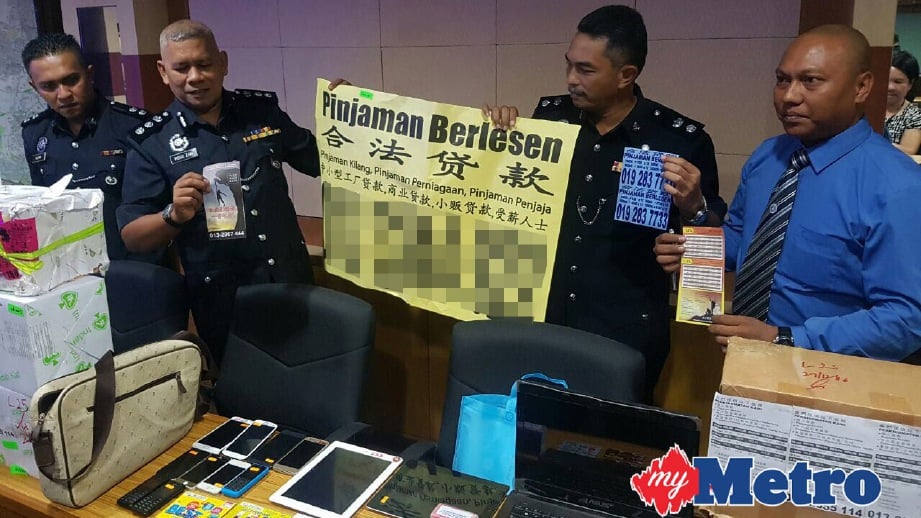 MOHD Zani (dua kiri) menunjukkan poster yang dirampas. FOTO Hafidzul Hilmi Mohd Noor