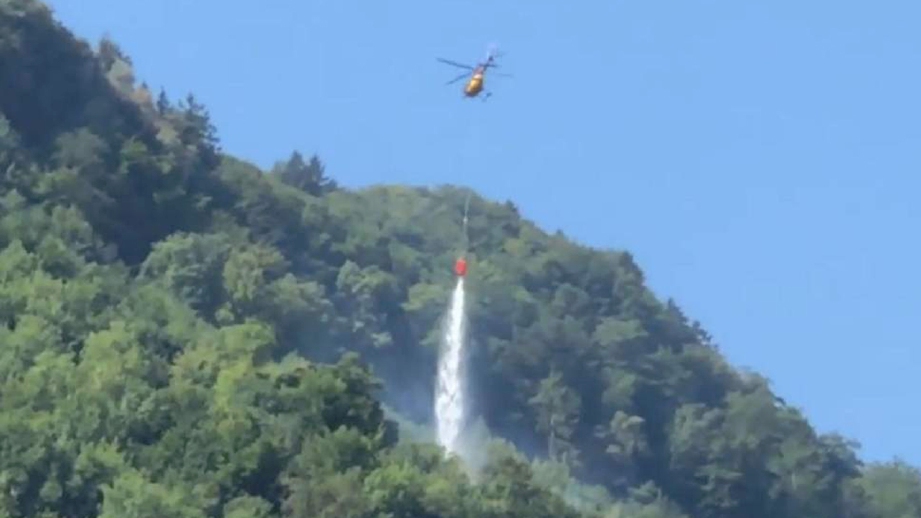 Helikopter memadamkan kebakaran dengan mencurah air di lokasi kejadian. FOTO Tage Anzeiger