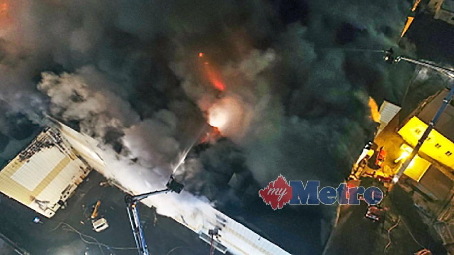 ANGGOTA bomba berusaha memadamkan kebakaran di pusat beli belah. FOTO AFP/RUSSIAN EMERGENCY SITUATIONS MINISTRY