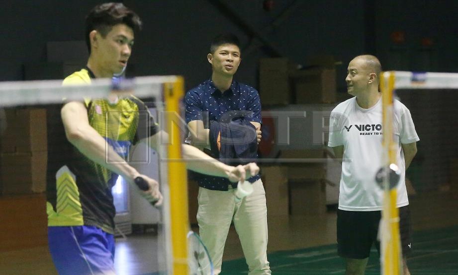 CHOONG Hann (tengah) bersama Hendrawan melihat pemain perseorangan lelaki negara menjalani latihan di Akademi Badminton Malaysia. Str/Owee Ah Chun.