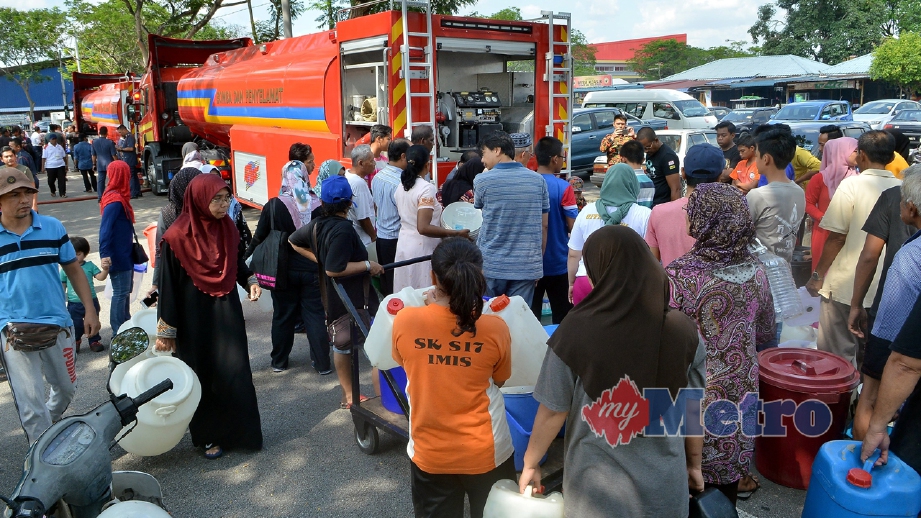 PENDUDUK  menerima bekalan air bersih dari lori tangki Jabatan Bomba dan Penyelamat Malaysia di Seksyen 17, Shah Alam. FOTO Faiz Anuar