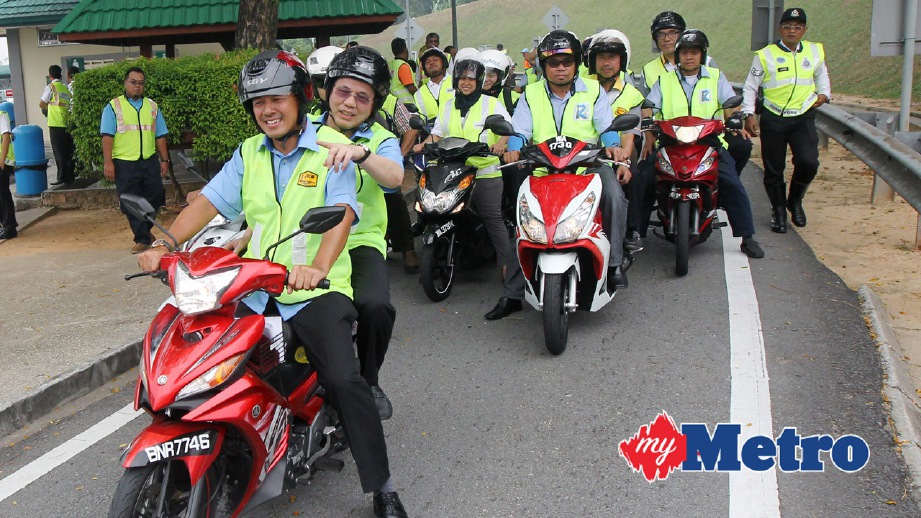 FADILLAH membonceng motorsikal bersama kakitangan Jabatan Kerja Raya ketika tinjauan sempena lawatan kerja di Lebuhraya Persekutuan. FOTO Intan Nur Elliana Zakaria