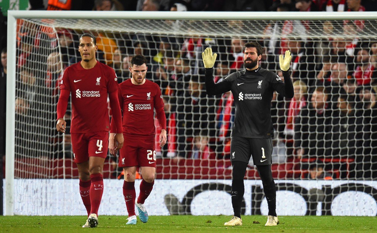 epa10482714 Liverpool goalkeeper Alisson Becker (R), Andy Robertson and Virgil van Dijk (L) react after Real Madrid scored their 5th goal during the UEFA Champions League, Round of 16, 1st leg match between Liverpool FC and Real Madrid in Liverpool, Britain, 21 February 2023.  EPA/Peter Powell