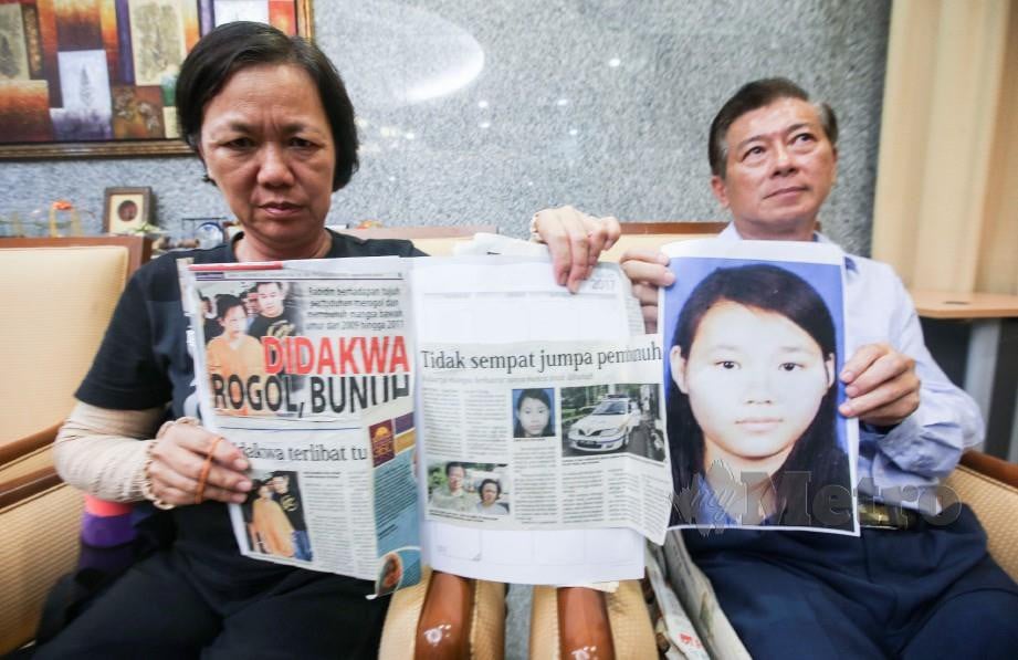 TAN Siew (kiri) bersama suaminya, Sew Kok Wee (kanan) menunjukkan keratan akhbar dan foto anaknya, Annie Kok Jin Cheng, yang mati dibunuh oleh Rambo Bentong pada 07 Mac 2009. FOTO AZHAR RAMLI