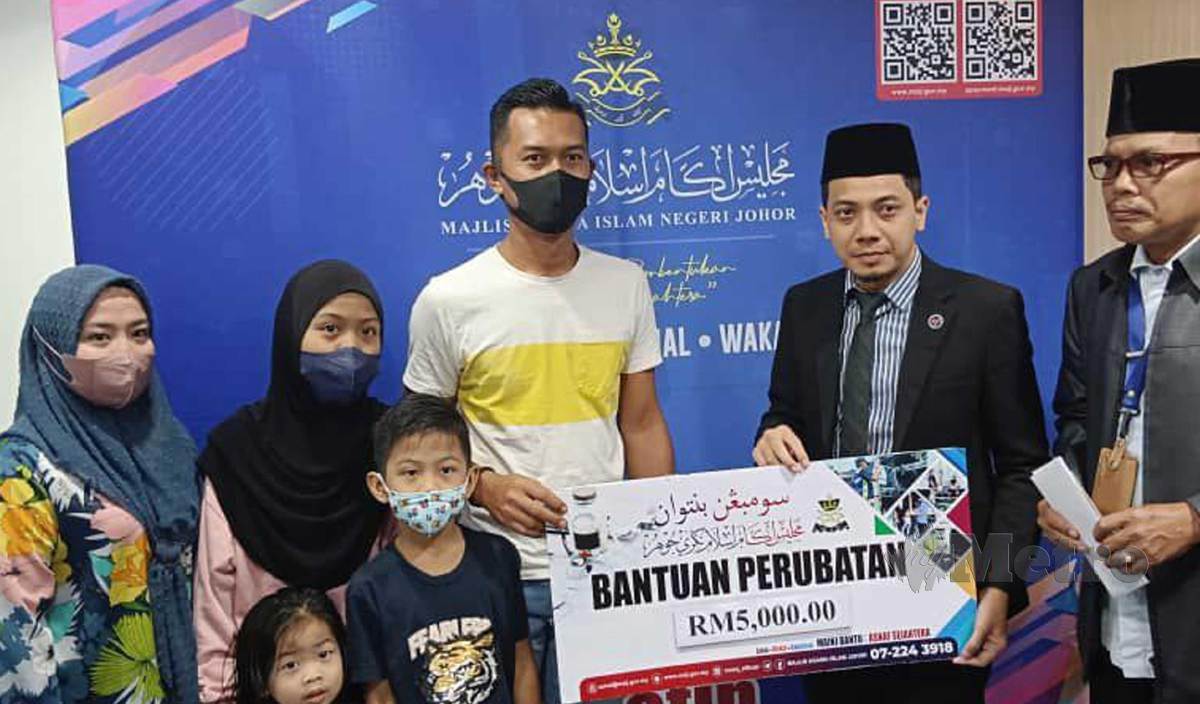MOHD Shafie (dua kanan) menyampaikan sumbangan zakat kepada bapa Damia, Mohd Rashid di Pusat Islam Iskandar Johor. FOTO Mary Victoria Dass