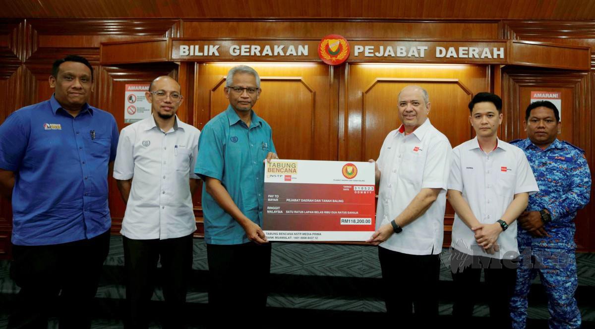 SYED Hussain (tiga kanan) menyerahkan replika cek kepada Pegawai Daerah Baling Mohd Shahadan Abdullah. FOTO Syaharim Abidin