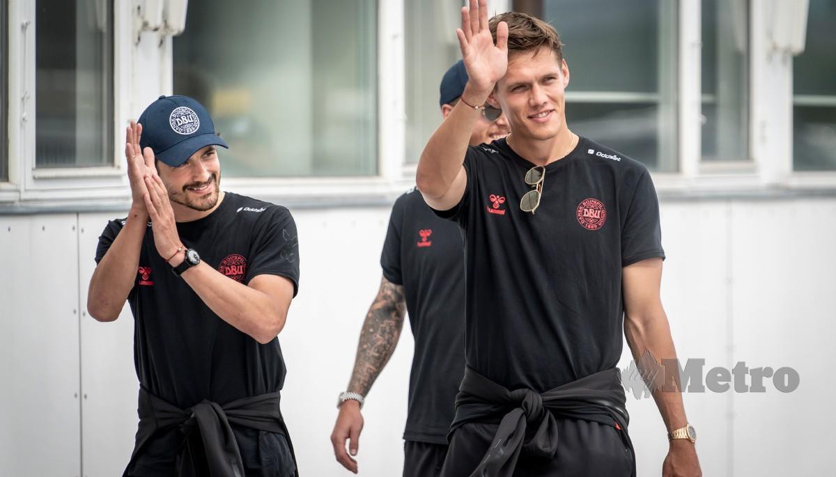 PEMAIN Denmark, Thomas Delaney (kiri) and Jannik Vestergaard melambaikan tangan kepada peminat sebaik tiba di Lapangan Terbang Copenhagen. FOTO EPA