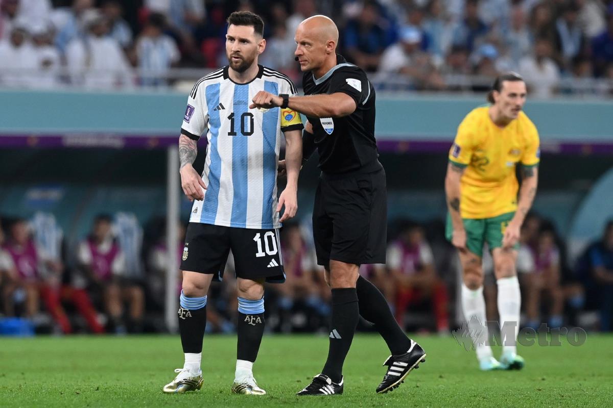 MARCINIAK (kanan) memperkatakan sesuatu dengan Lionel Messi ketika mengendalikan perlawanan 16 terakhir antara Argentina dengan Australia. FOTO EPA
