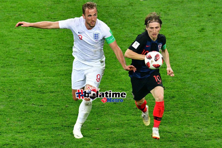 PEMAIN England, Kane (kiri) mengasak pemain Croatia, Modric (kanan). Foto/AFP 