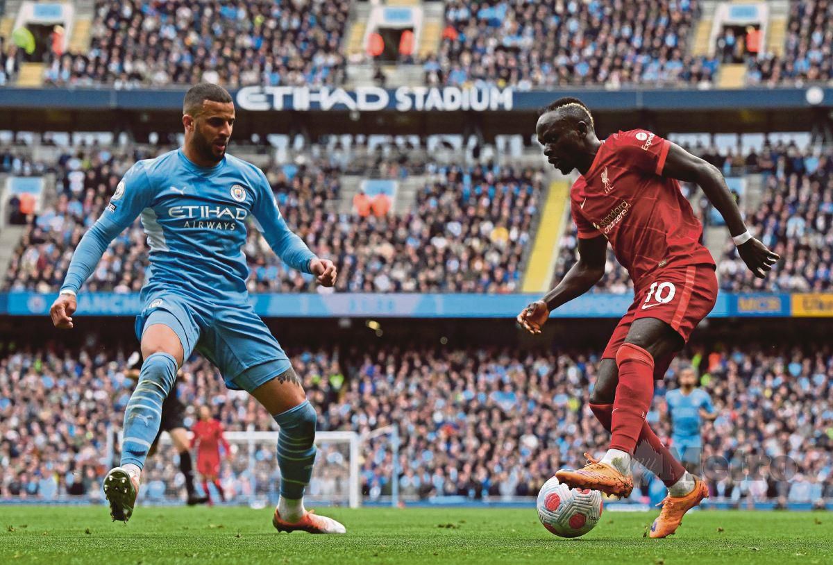 PEMAIN pertahanan Manchester City, Kyle Walker (kiri) cuba menghalang penyerang Liverpool, Sadio Mane ketika seri 2-2, semalam. FOTO AFP
