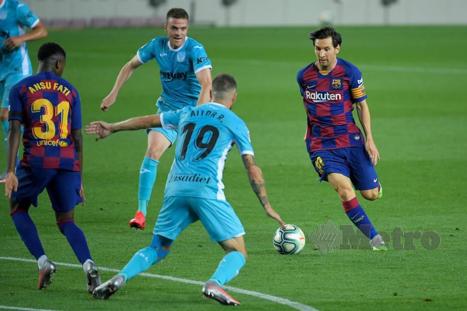 Penyerang Barcelona, Lionel Messi (kanan) sentiasa memberi ancaman di barisan pertahanan lawan. FOTO AFP