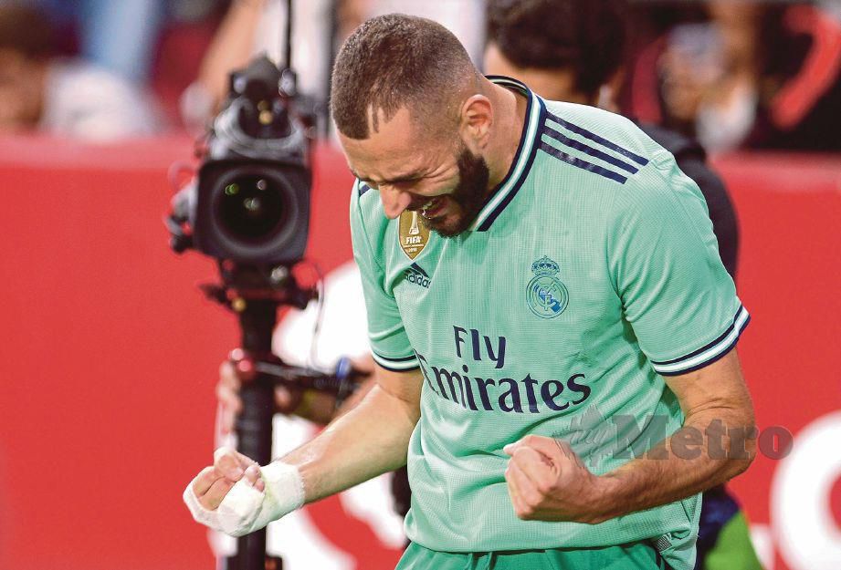 GAYA Benzema selepas menjaringkan gol Real  di Seville. - FOTO AFP
