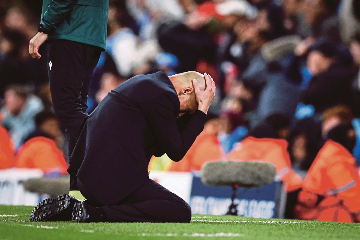 GUARDIOLA kecewa selepas Manchester City tewas di tangan Real Madrid di suku akhir UCL, awal pagi tadi. FOTO AFP 