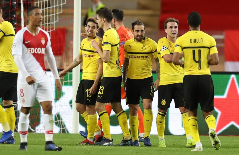 PEMAIN Dortmund meraikan kemenangan 2-0 ke atas Monaco pada aksi di Stadium Louis II. FOTO AFP