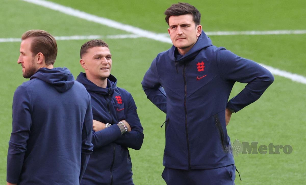 PEMAIN pertahanan England, Kieran Trippier (tengah) bersama Harry Maguire (kanan) memeriksa keadaan padang di Wembley sebelum perlawanan separuh akhir dengan Denmark, semalam. FOTO AFP