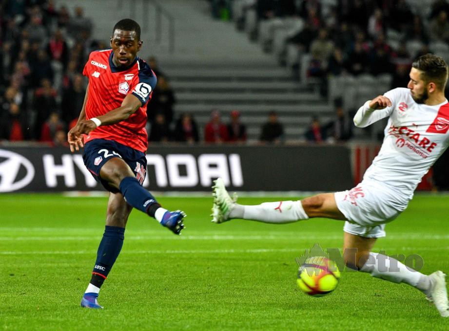 Pemain tengah Lille, Boubakary Soumare (kiri) diasak oleh pertahanan Nimes, Gaetan Paquiez pada aksi Ligue 1. FOTO AFP.