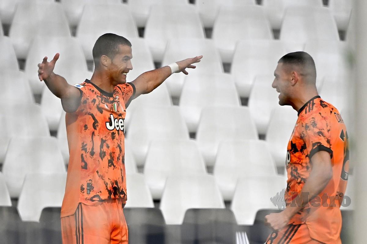 RONALDO meraikan kejayaan selepas meledakkan gol kedua Juve. FOTO AFP 