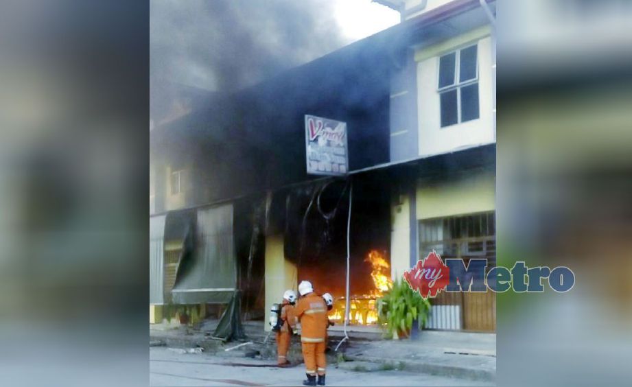 ANGGOTA bomba berusaha memadamkan api di sebuah restoran menyediakan hidangan dim sum di Bandar Letat, dekat Batu 3 1/2 di Sandakan. Foto NSTP/IHSAN BOMBA.