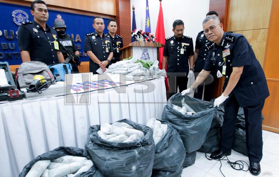 HASANUDDIN (kanan) bersama pegawainya menunjukkan rampasan 487kg daun ketum dan 4,040 biji pil yaba pada sidang media di Bilik Media Ibu Pejabat Polis Kontinjen (IPK) Kelantan di Kota Bharu, hari ini. FOTO Syamsi Suhaimi. 