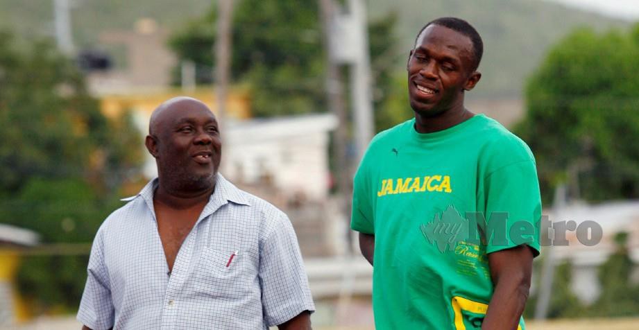 Glen Mills (kiri) berbincang bersama juara Olimpik, Usain Bolt ketika latihan. FOTO File Reuters