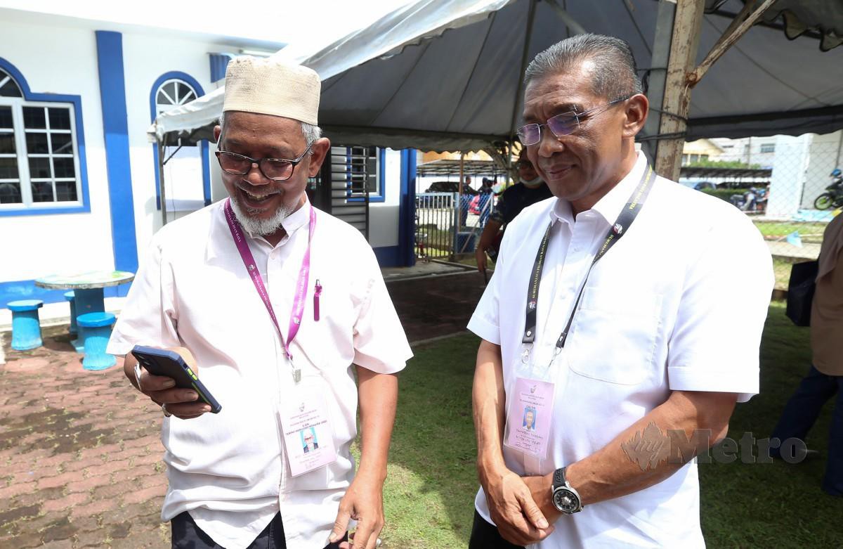 TAKIYUDDIN dan calon Pas Parlimen Kota Bharu (kanan) ketika hadir meninjau proses pengundian awal di Taska IPK Kelantan. FOTO Nik Abdullah Nik Omar.