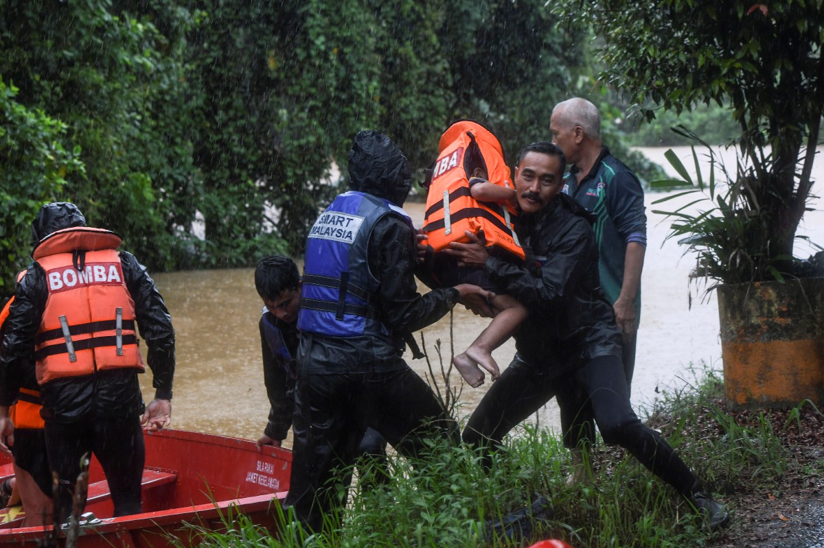 ANGGOTA Pasukan Mencari Dan Menyelamat Khas Malaysia (SMART) menyelamatkan  mangsa banjir di Kampung Kepah hari ini. FOTO Bernama.