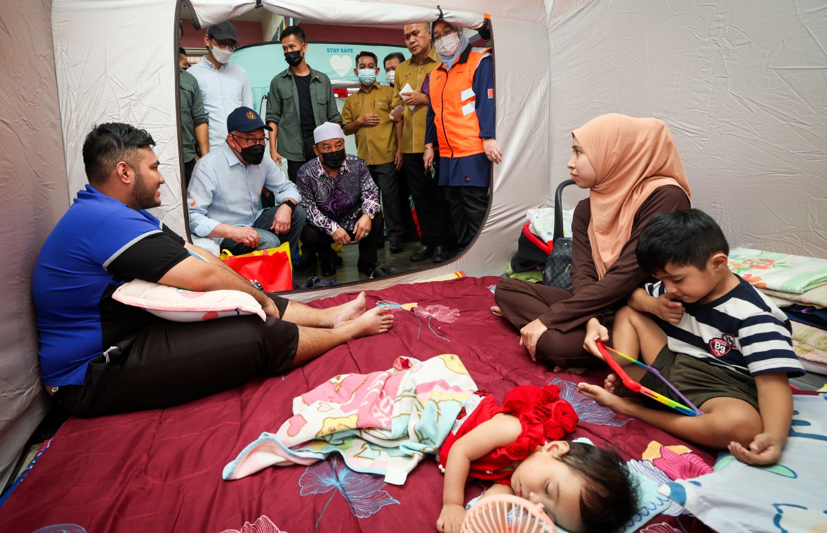 ANWAR (dua kiri) melawat mangsa banjir yang ditempatkan di PPS SMK Agama Lati di Pasir Mas, Kelantan hari ini. FOTO Bernama