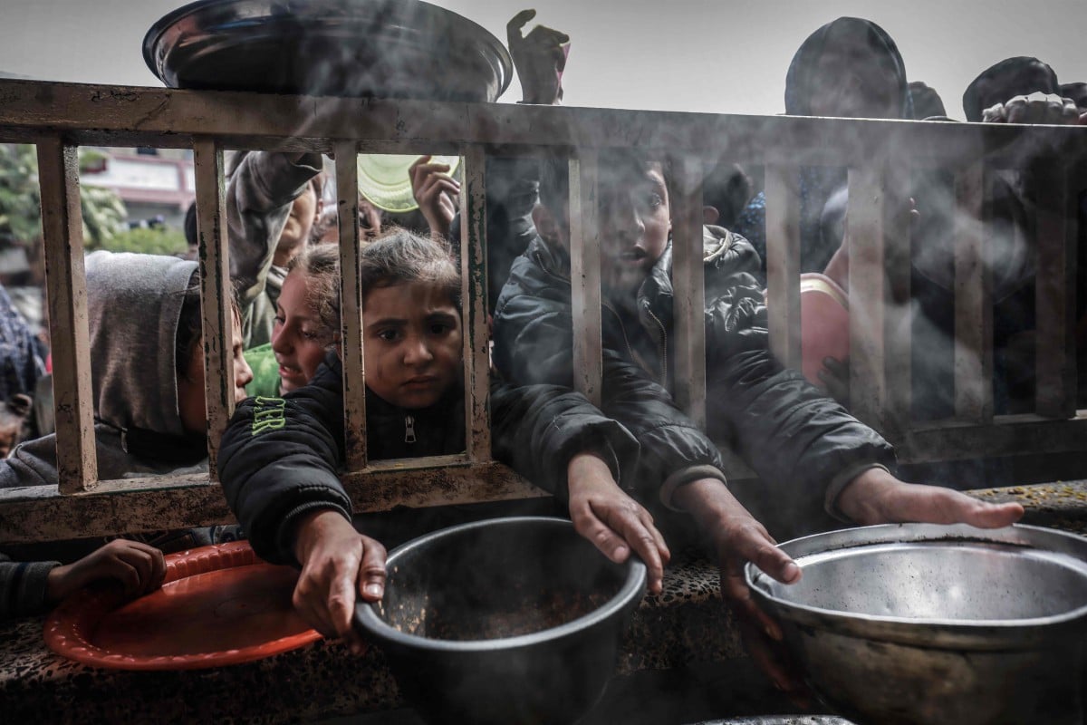 KANAK-kanak Palestin berkumpul untuk mendapatkan makanan di sebuah sekolah kerajaan di Rafah. FOTO AFP