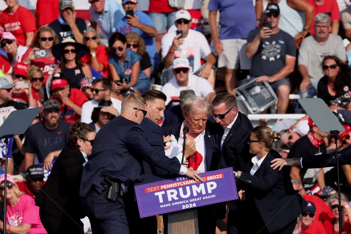 DONALD Trump dibantu ejen perkhidmatan rahsia selepas insiden tembakan ketika sedang berkempen di Butler, Pennsylvania. FOTO Reuters