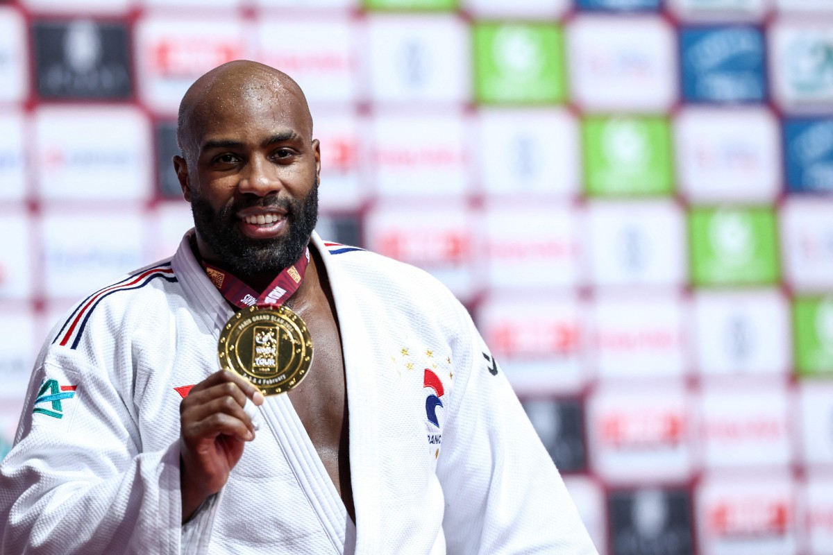 France's Teddy Riner poses with his gold medal on the podium of the men's +100kg final bout during the Paris Grand Slam judo tournament in Paris on February 4, 2024. (Photo by EMMANUEL DUNAND / AFP) / ALTERNATE CROP