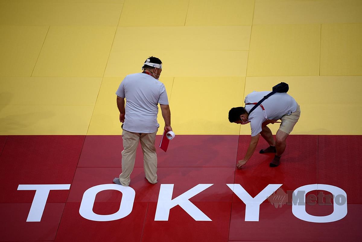 SUKARELAWAN sedang menyiapkan gelanggang judo dan karate di Nippon Budokan untuk aksi Olimpik Tokyo 2020. FOTO AFP