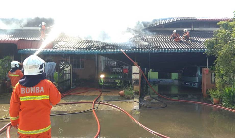 ANGGOTA bomba sedang melakukan operasi pemadamana di tiga rumah yang terbakar di Persiaran Pegoh, Taman Pengkalan Jaya, Ipoh. FOTO Ihsan JBPM Perak