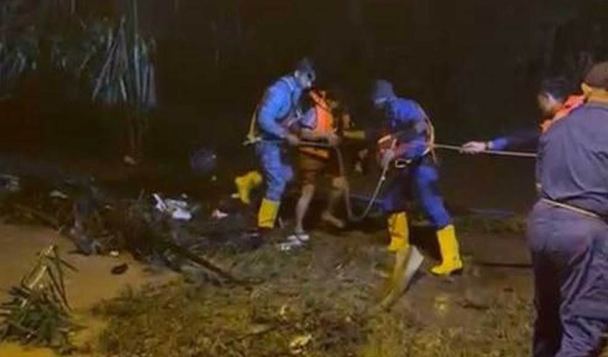 ANGGOTA APM Port Dickson sedang menyelamatkan mangsa seorang warga emas yang terperangkap dalam kebunnya di Kampung Tanah Merah Site C, Chuah, Port Dickson malam tadi. FOTO Ihsan APM Port Dickson