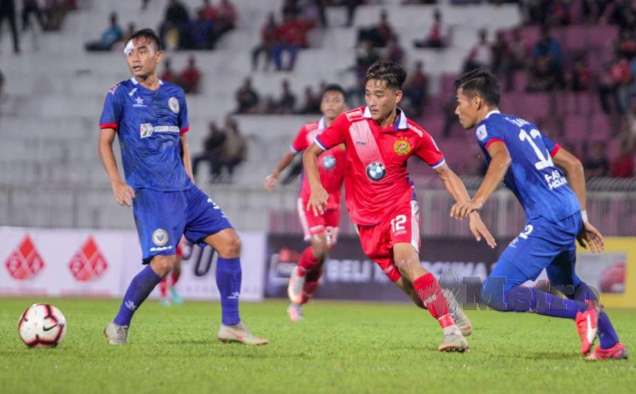Pemain Kelantan, Mohamad Hakimi Abdullah (dua kanan) dikawal pemain Sarawak, dalam aksi Liga Perdana. FOTO Syamsi Suhaimi.