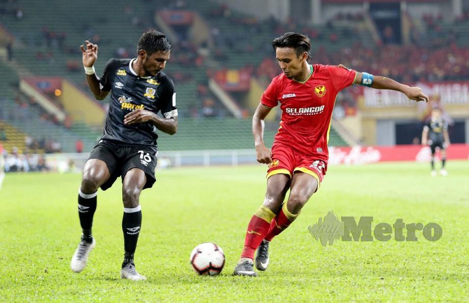 Amri Yahya menggelecek pemain Perak, K Partiban dalam aksi Liga Super di Stadium Shah Alam. FOTO Roslin Mat Tahir.