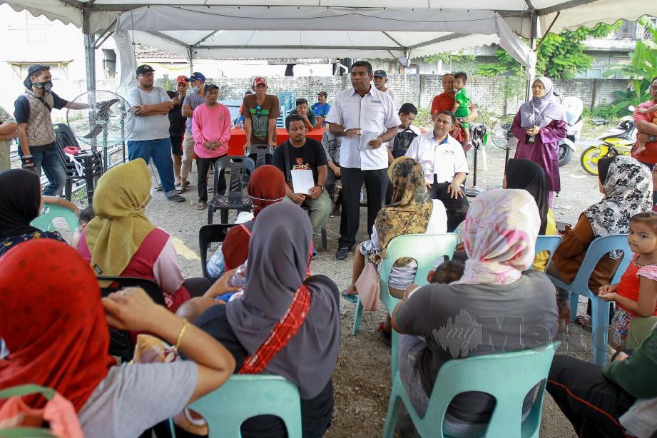 Abdul Basith (tengah) bertemu penduduk di pusat penempatan sementara penduduk di Kampung Paya Jaras Hilir, Sungai Buloh hari ini. Foto Asyraf Hamzah 