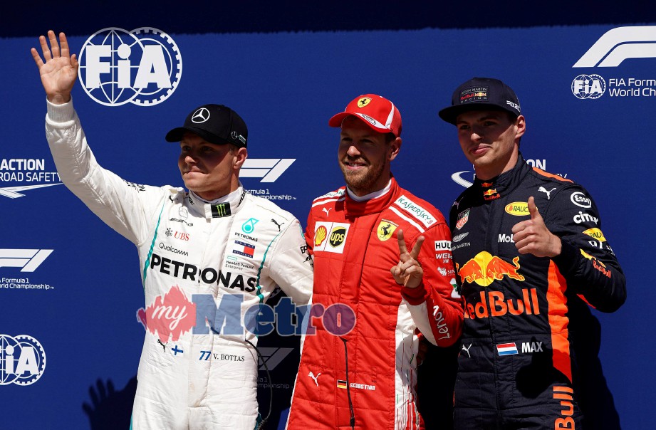 PEMAIN Ferrari, Sebastian Vettel (tengah) meraih petak pertama pada sesi kelayakan di GP Kanada. FOTO Reuters
