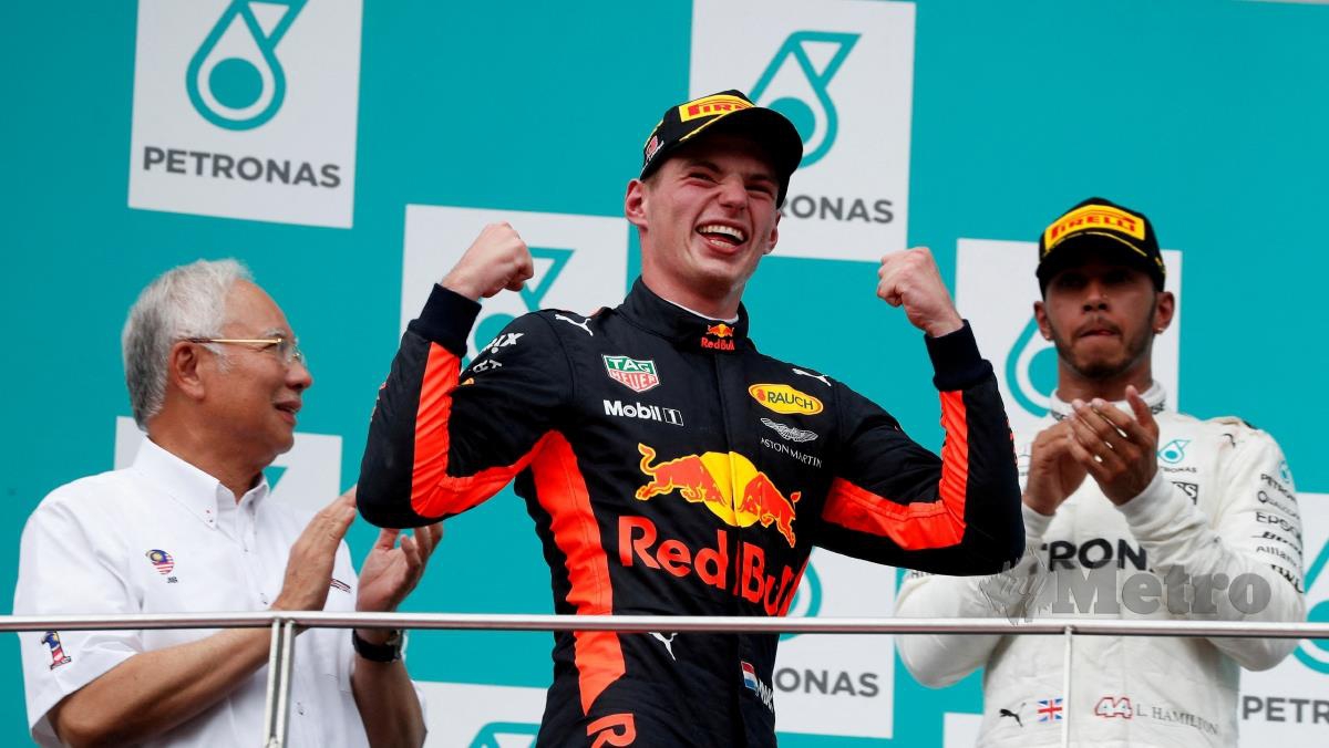 PEMANDU Redbull, Max Verstappen (tengah) meraikan kemenangan di GP Malaysia pada 2017 sambil disaksikan Perdana Menteri ketika itu, Datuk Seri Najib Razak dan pemandu Mercedes, Lewis Hamilton. FOTO FAIL REUTERS 