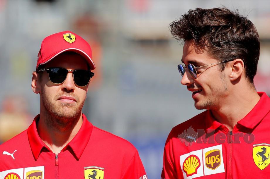 Pelumba Ferrari, Sebastian Vettel (kiri) dan Charles Leclerc berbincang ketika perlumbaan di GP Russia, Sochi. FOTO Reuters